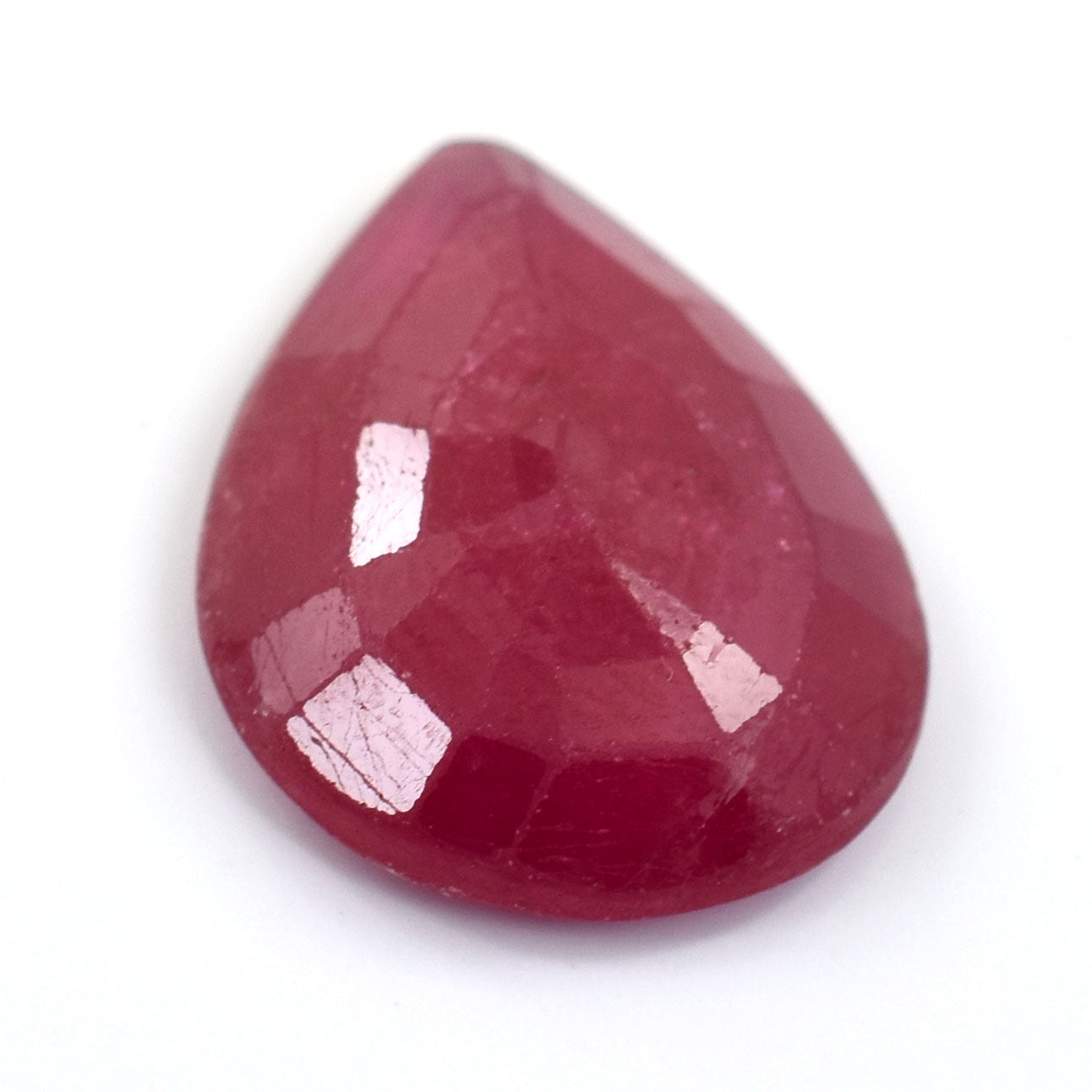 Pear-shaped ruby gemstone with a deep red color and faceted surface.