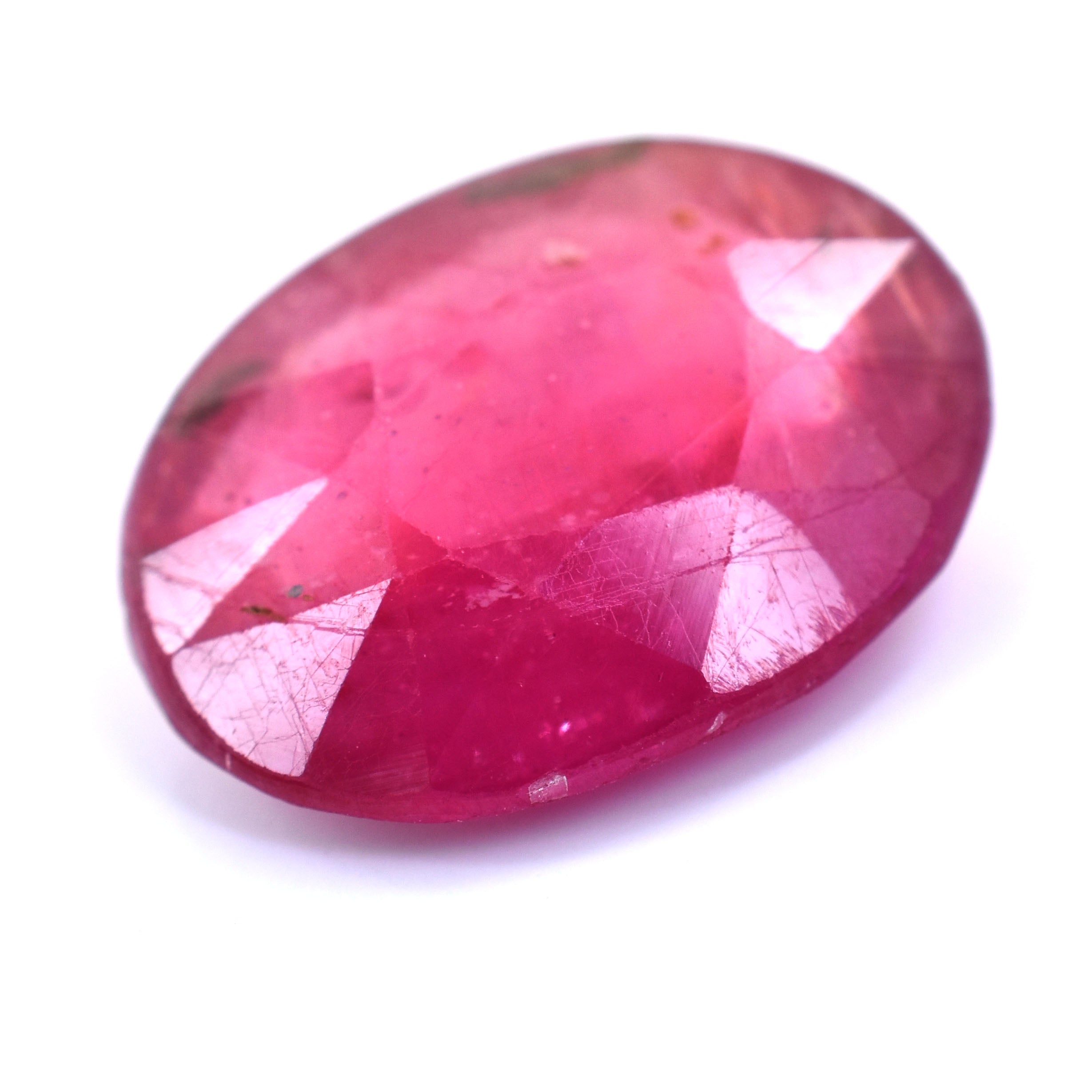 Oval-cut pink gemstone with faceted surfaces.