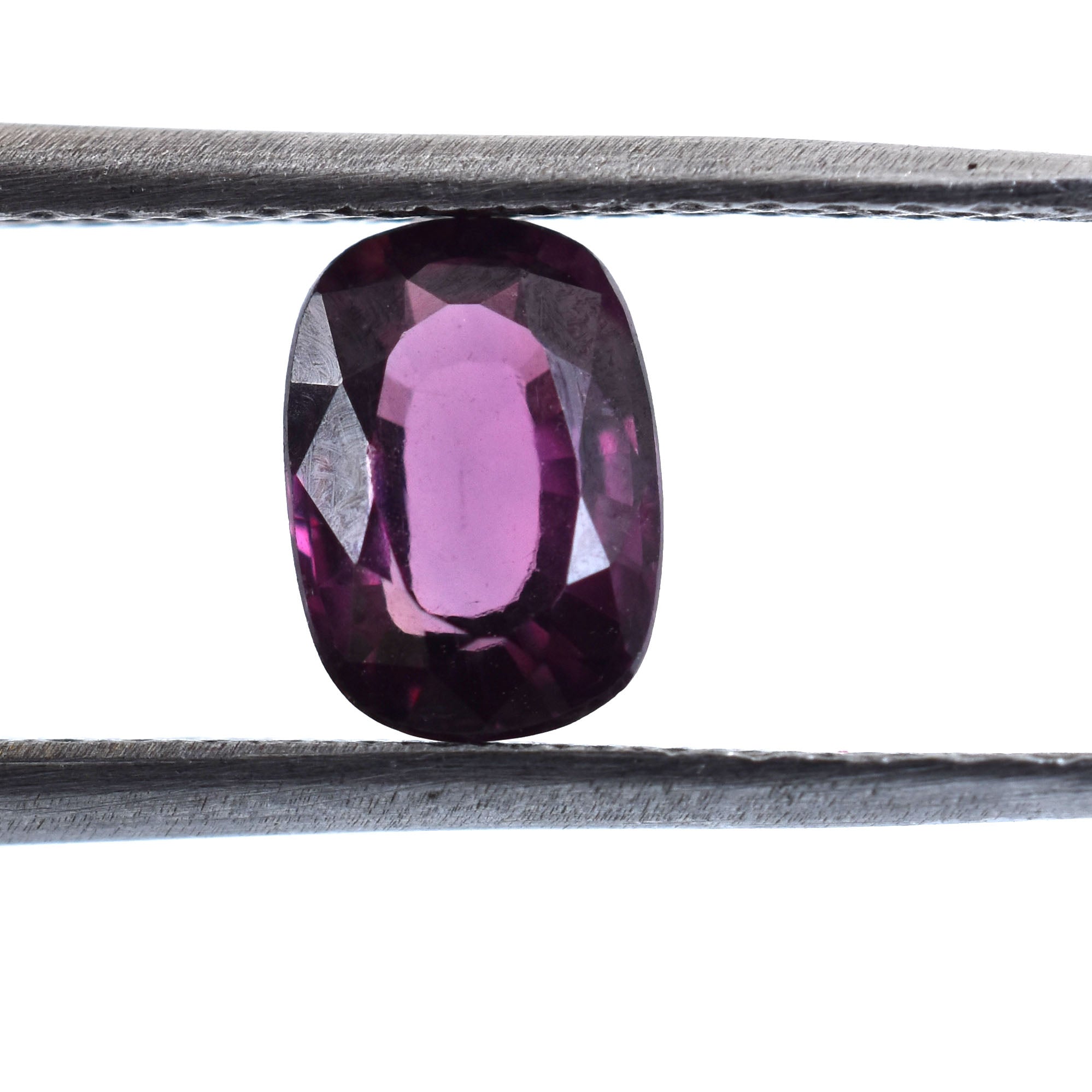 Oval-cut purple gemstone, likely an amethyst or sapphire.