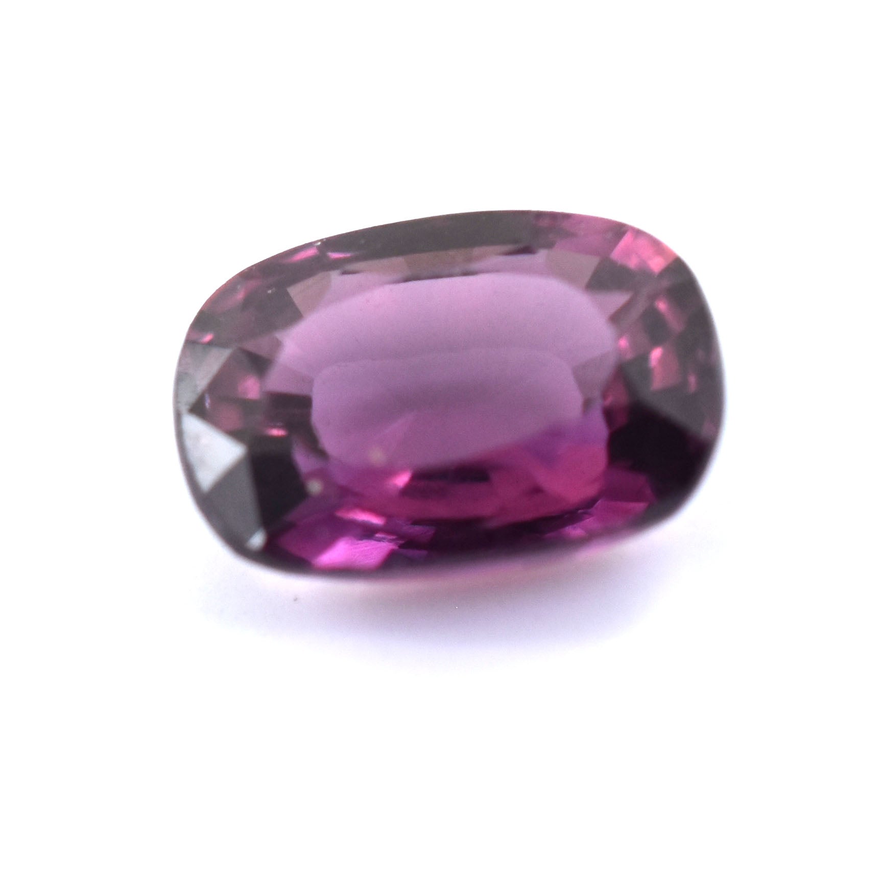 Faceted purple gemstone with an oval cut.