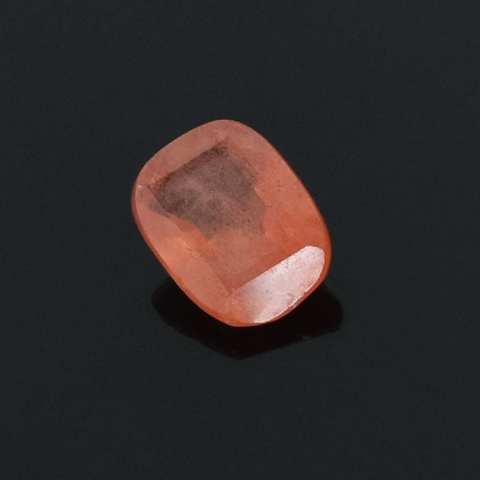 Polished pink gemstone or crystal with a rounded, cushion-like shape.