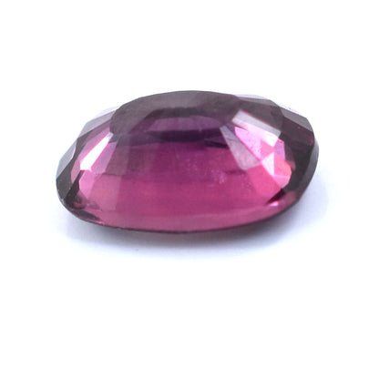 Faceted purple gemstone with a deep pink hue.