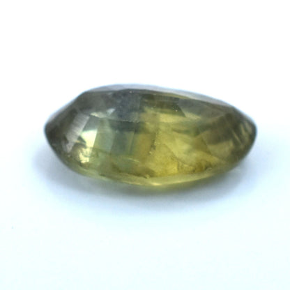 Oval-shaped gemstone with a greenish-yellow hue.