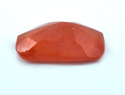 Faceted, polished red gemstone or crystal with a smooth surface.