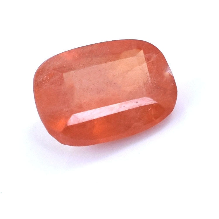 Faceted orange-pink gemstone with a cushion cut shape.