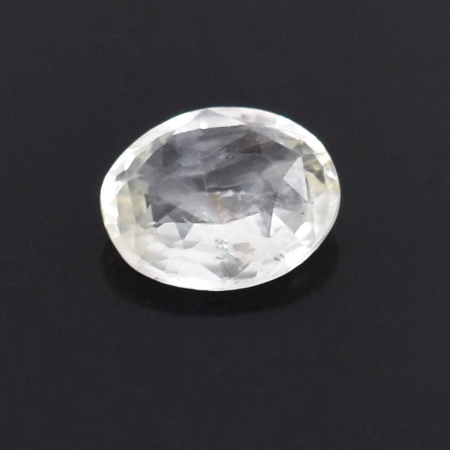 Oval-cut, colorless gemstone, likely a diamond, with visible facets.