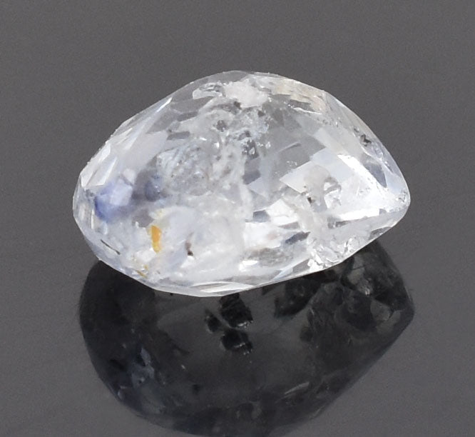 Cut and polished diamond gemstone with visible facets and internal reflections.