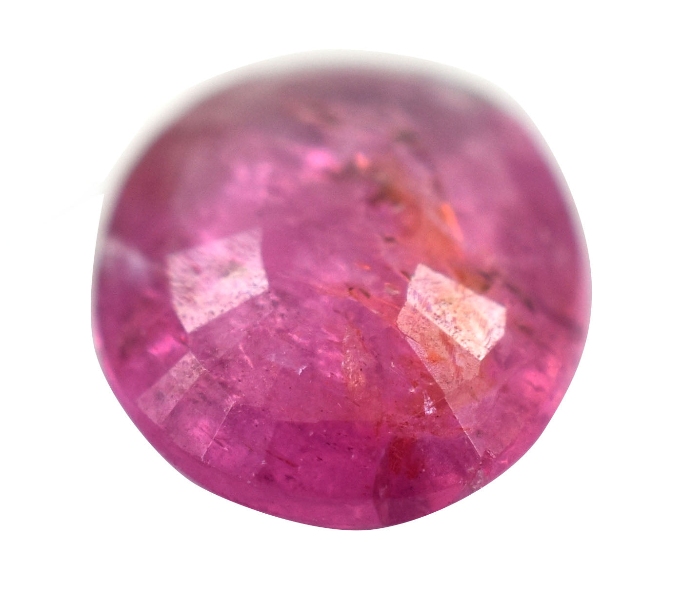 Vibrant pink gemstone with faceted cuts reflecting light.