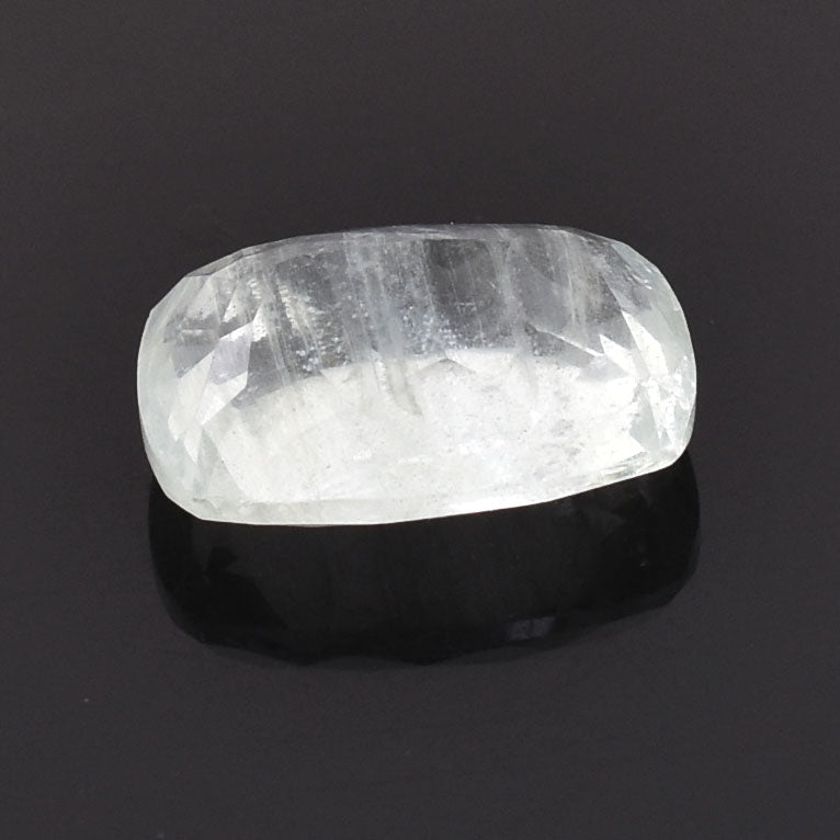 Polished, translucent white crystal or gemstone with a rounded rectangular shape.