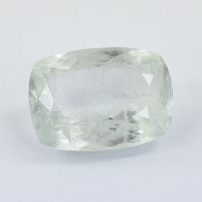 Cushion-cut pale gemstone with facets and a slightly cloudy appearance.