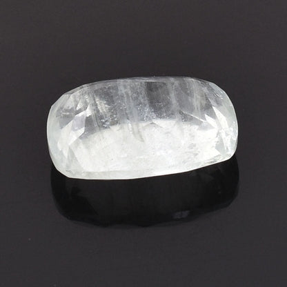 Polished, translucent white crystal or gemstone with a rounded rectangular shape.